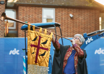 A person playing a wind instrument at a groundbreaking ceremony