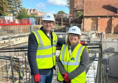 Two people standing in front of the Norham St Edmund construction works