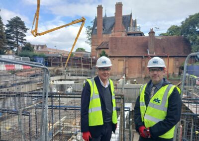 Two people standing in front of the Norham St Edmund construction works