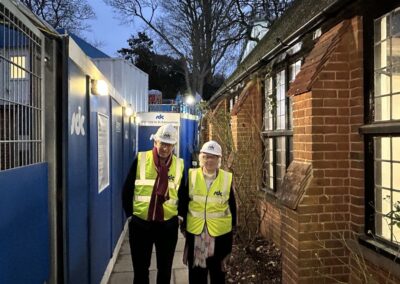 Two people standing at the Norham St Edmund construction site