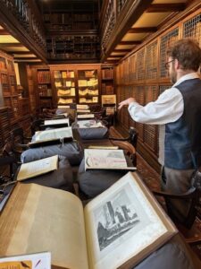 A picture of the old library at St Edmund Hall, the walls all covered by books, the long table central in the room