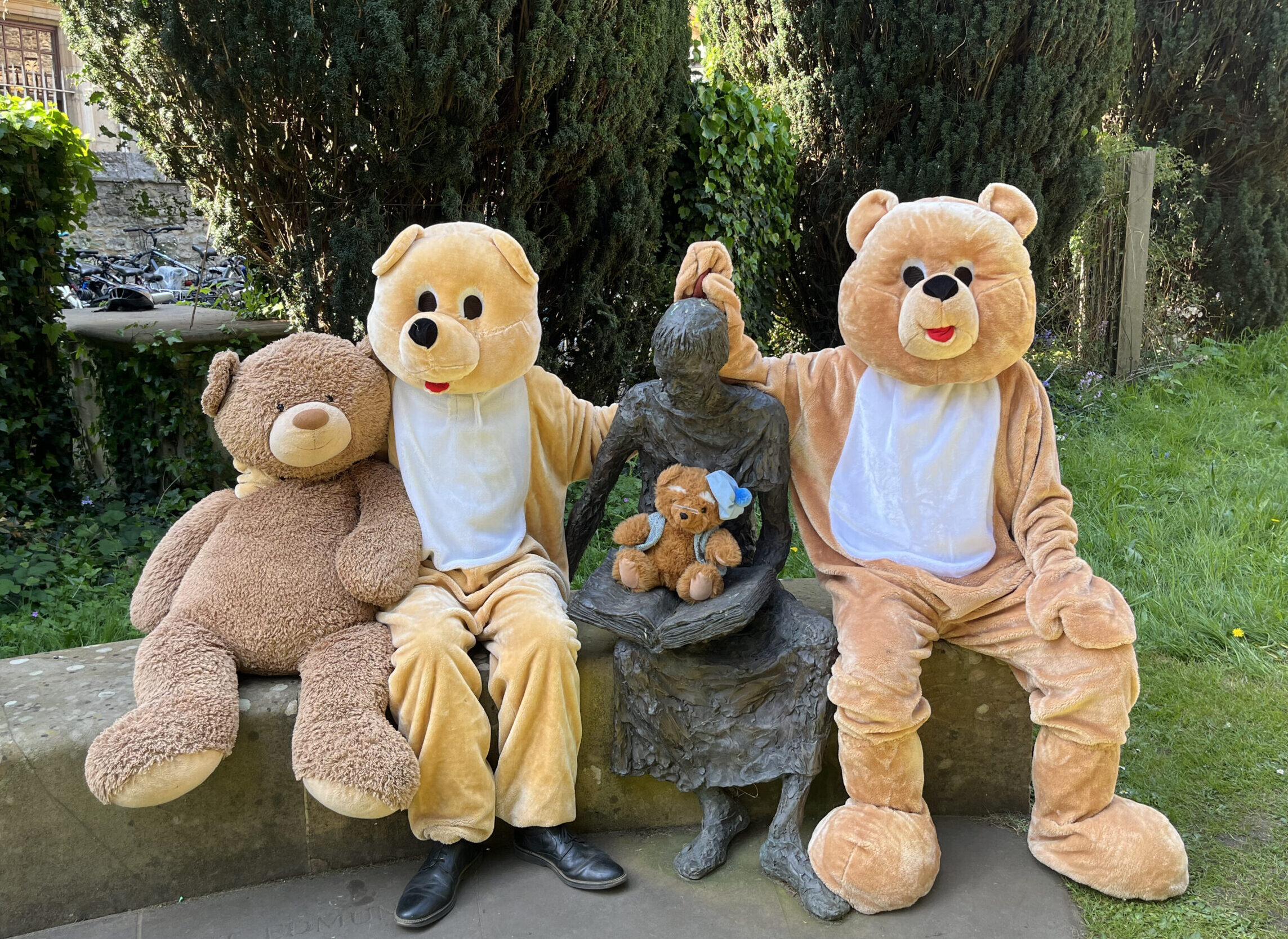 Two bears sitting next to a statue of St Edmund of Abingdon